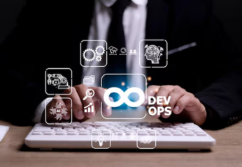 A person in a business suit typing on a keyboard with a glowing 'DevOps' infinity symbol and various tech icons overlaid.