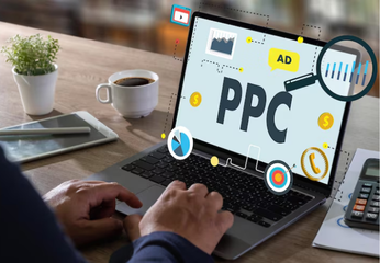 Person using laptop showing a PPC (pay-per-click) advertising dashboard.