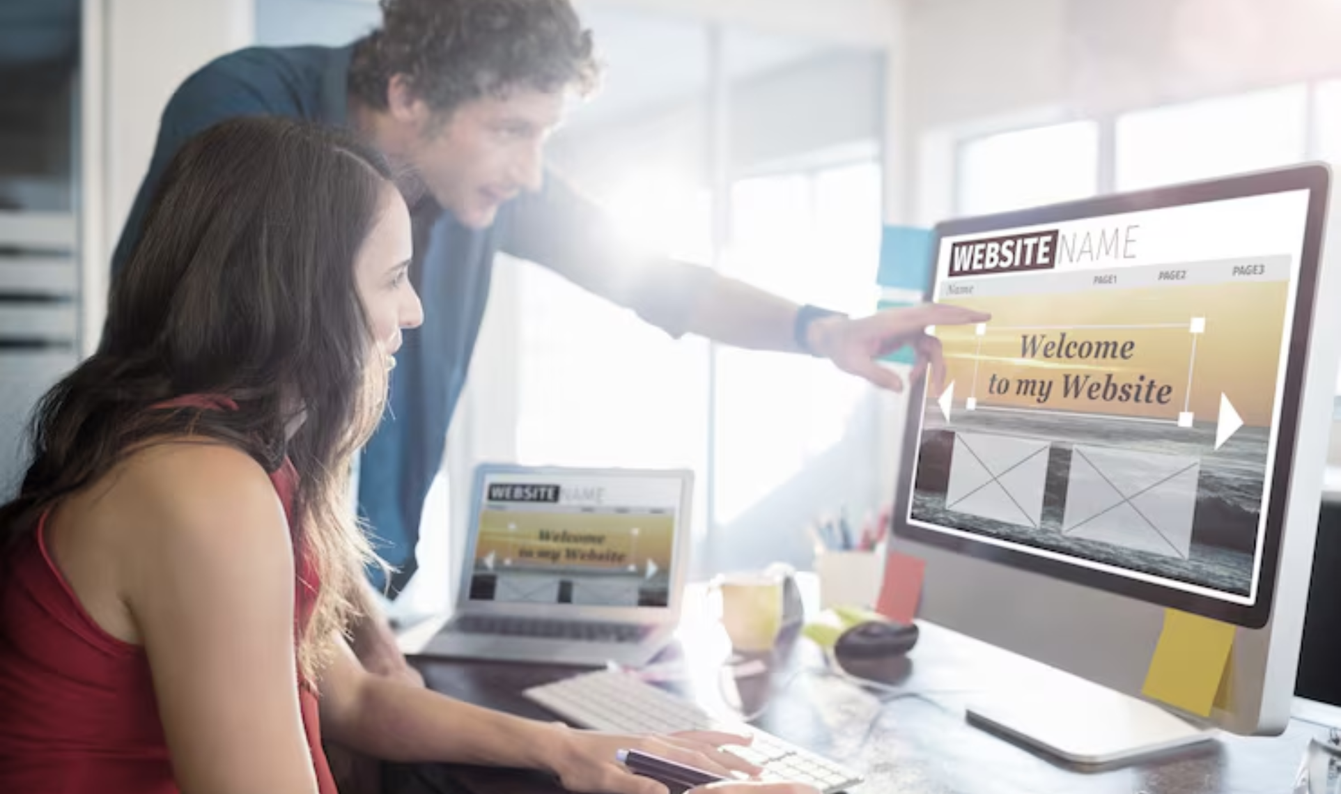 Two people collaborating on a Website Redesign & Optimization project, reviewing and updating a website layout on a desktop screen.